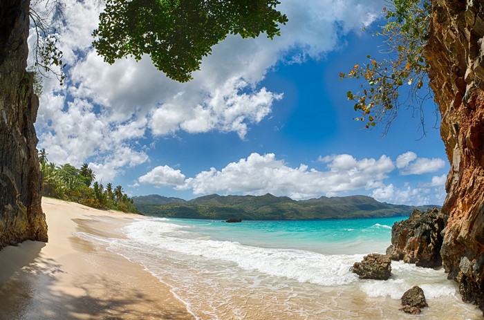 Tropical beach with turquoise water and mountains