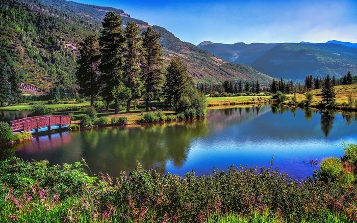 Scenic mountain lake with a wooden bridge
