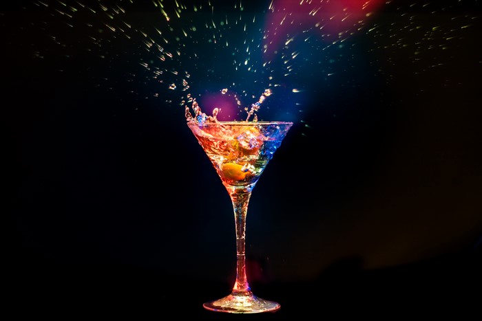 Cocktail splash with colorful lighting