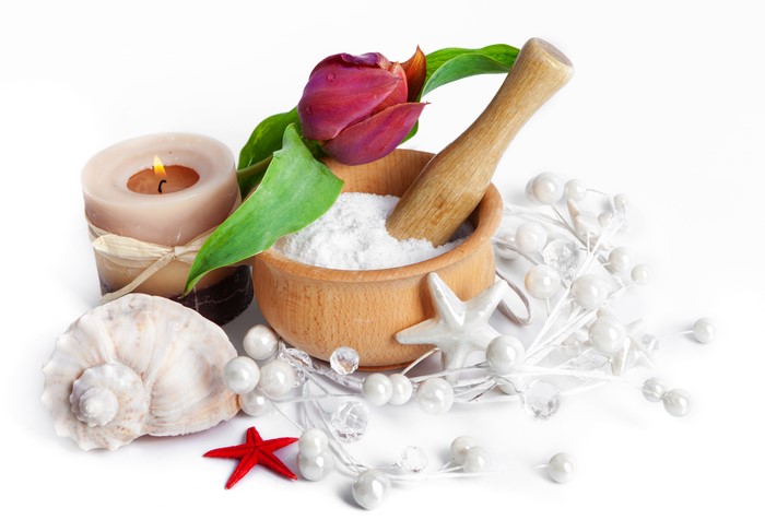 Spa arrangement with tulip, candle, shells, and mortar