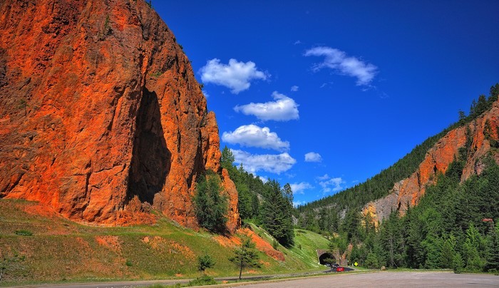 Red rock cliffs and a tunnel through a mountain pass