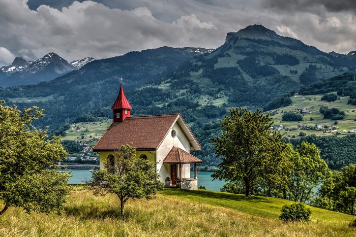 Chapel in the Swiss Alps with Mountains and Lake