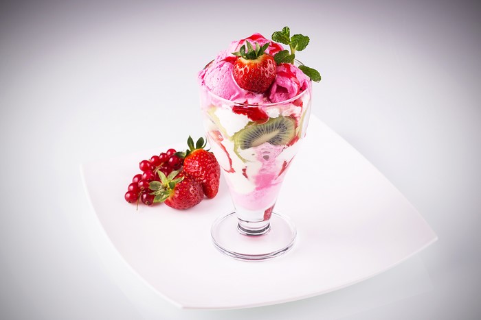 Ice cream sundae with strawberries and currants