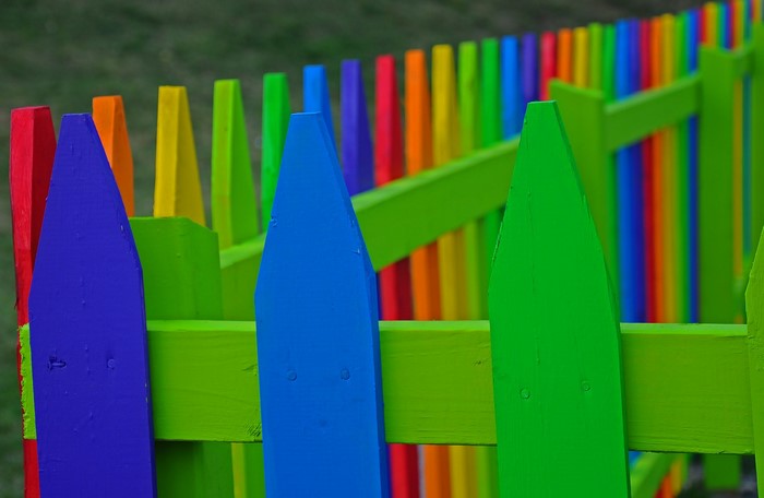 Colorful picket fence with green horizontal rails