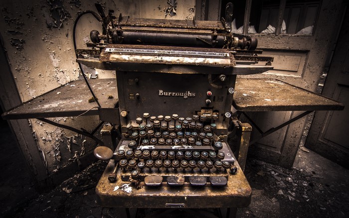 Burroughs typewriter in an abandoned room