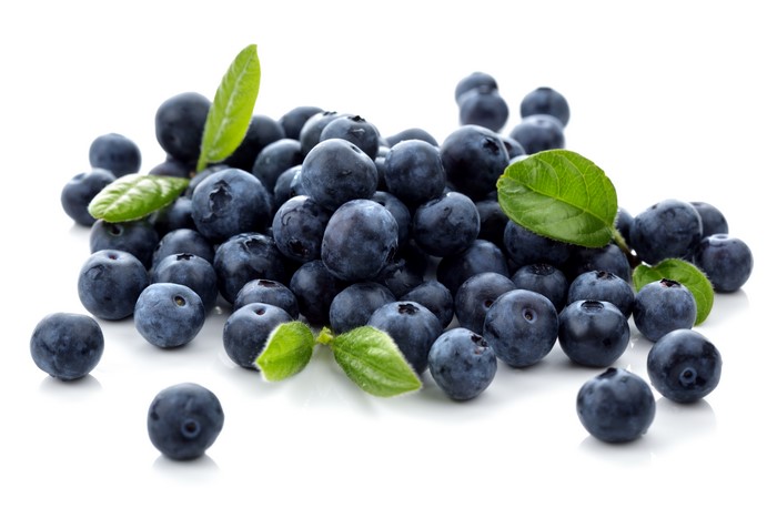 Blueberries with green leaves