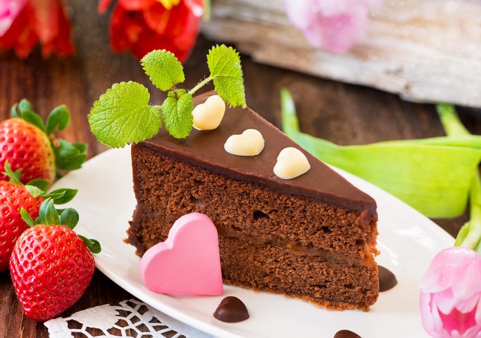 Slice of Chocolate Cake with Strawberries and Hearts