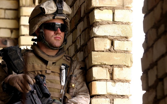 Soldier in tactical gear and helmet with sunglasses