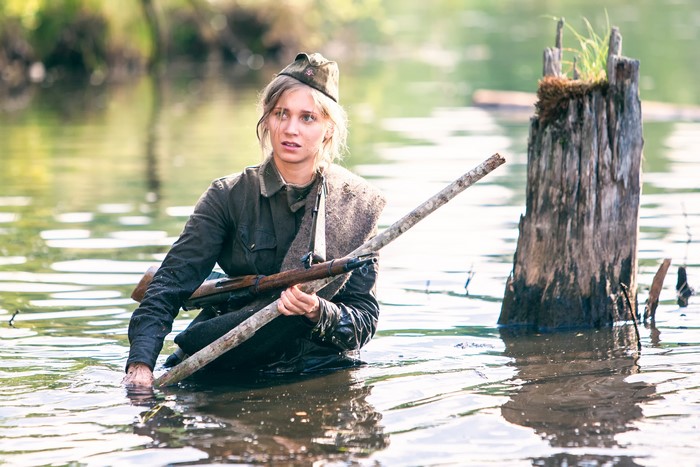 Soldier in water with rifle from The Dawns Here Are Quiet