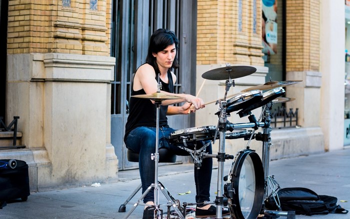 Man playing drums on a street