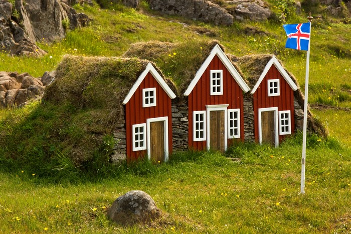 Traditional Icelandic Turf Houses with Flag