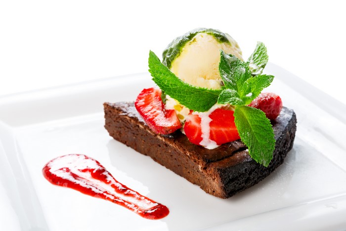 Chocolate brownie with ice cream and strawberries