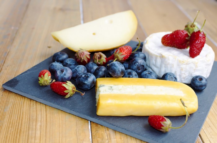 Cheese platter with blueberries and strawberries
