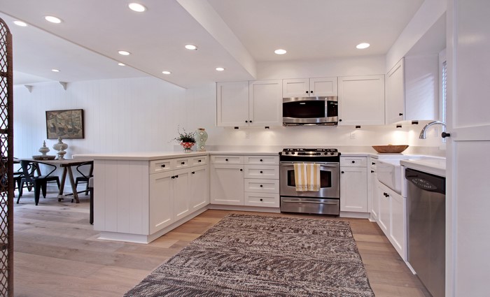 Modern white kitchen with island and dining area