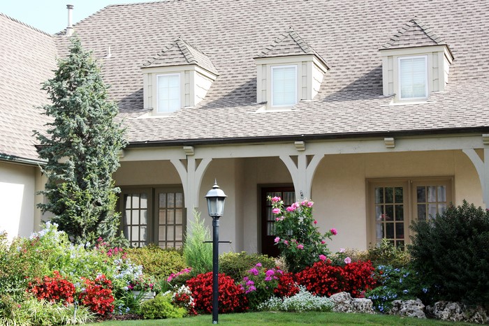 House with dormer windows and colorful garden