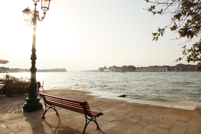 Venice canal with street light and bench
