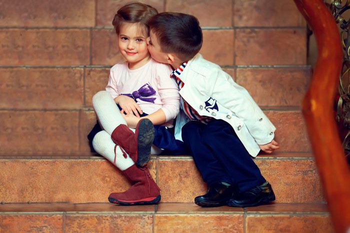 Boy kissing a girl on the stairs