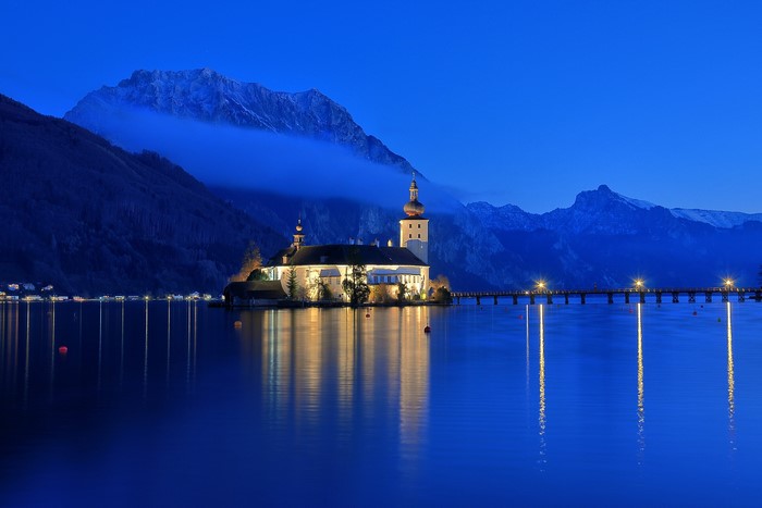 Schloss Ort castle on Traunsee lake at night, Austria