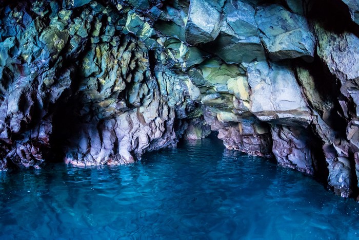 Blue water inside a rocky cave