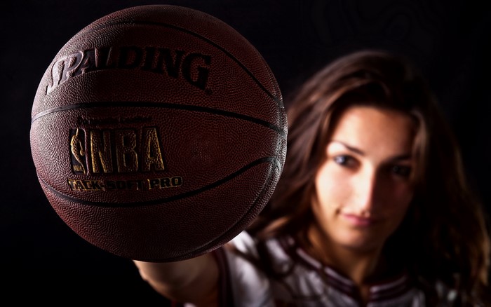 Woman holding a Spalding NBA basketball