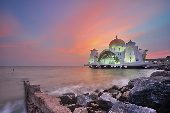 Strait Mosque on the sea at sunset