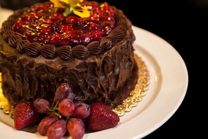 Chocolate cake with fruit topping and berries