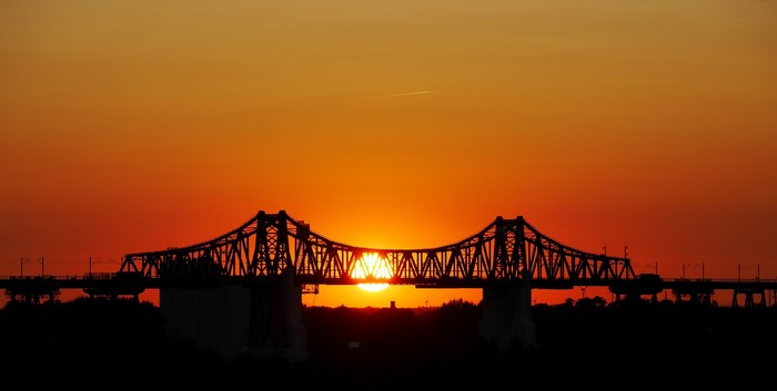 Bridge silhouetted against a sunset