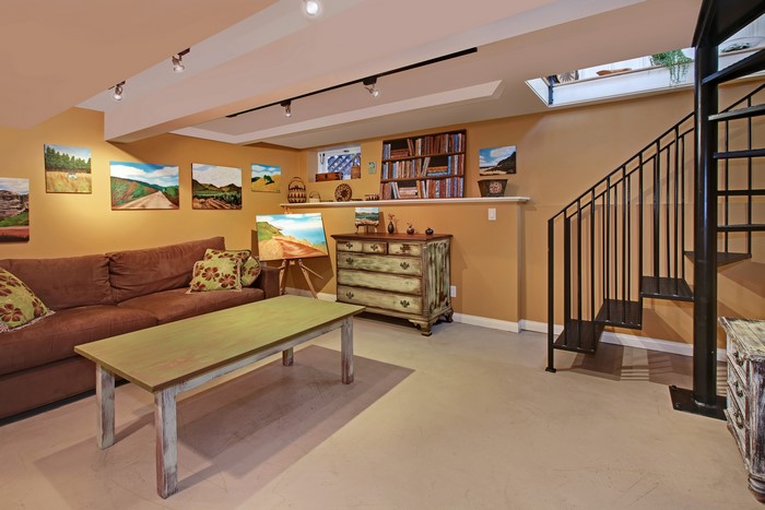 Living room with sofa, table, and stairs