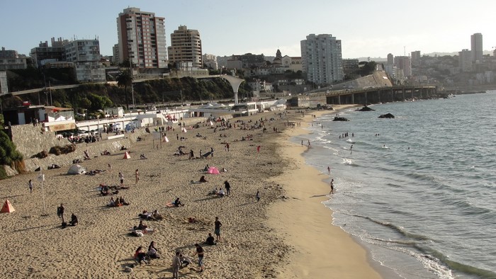 People relaxing on a beach in Valparaiso, Chile