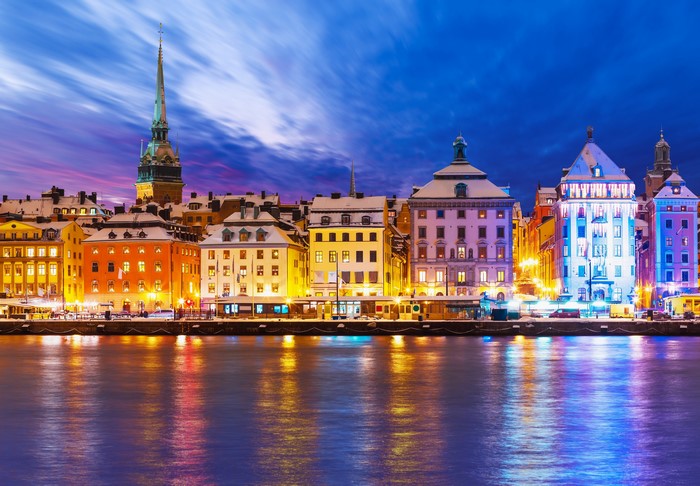 Stockholm waterfront buildings at night with snow