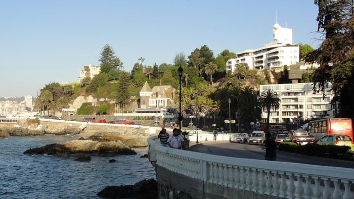 Coastal city with buildings on a hill overlooking the ocean