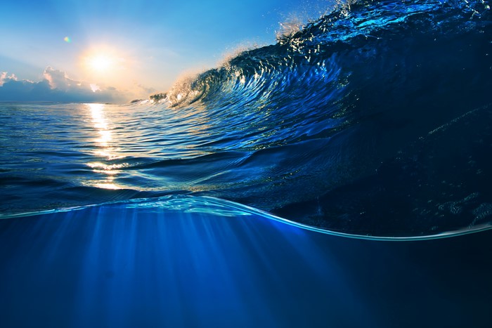 Ocean wave at sunset