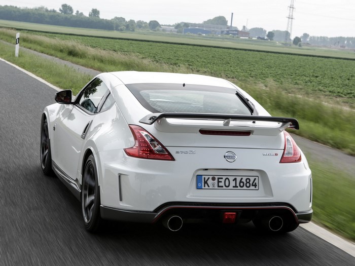 White Nissan 370Z Nismo driving on a road