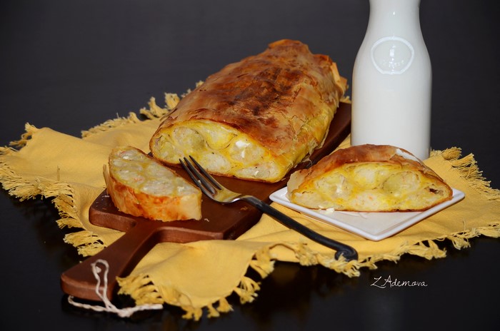 Baked pastry with filling and a bottle of milk