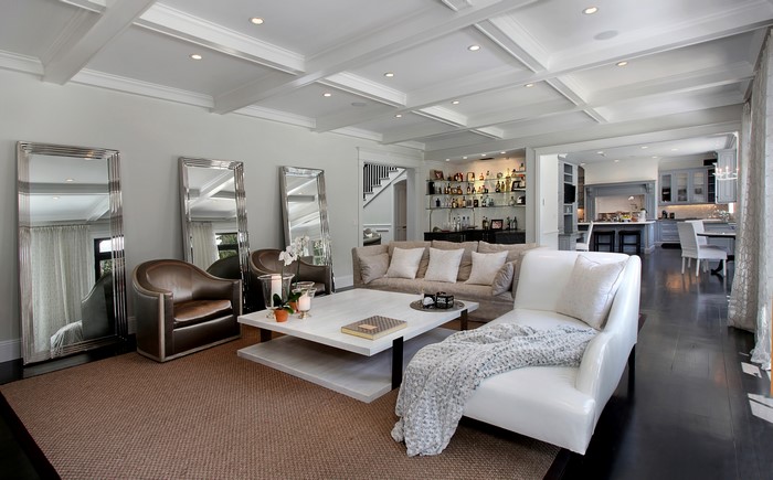 Living room with sofa, mirrors, and bar