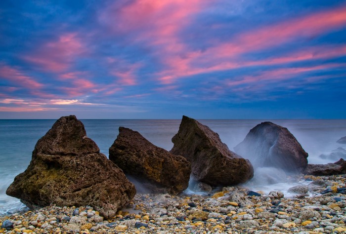 Rocky Shoreline at Sunset with Pink Clouds