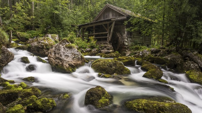 Watermill by a stream in a forest in Austria