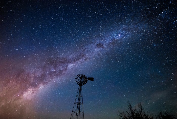 Milky Way over a windmill at night