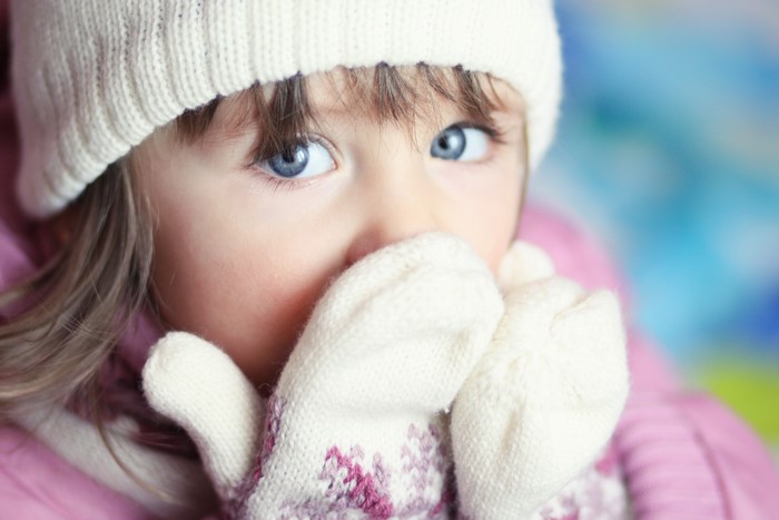 Little girl in winter hat and mittens