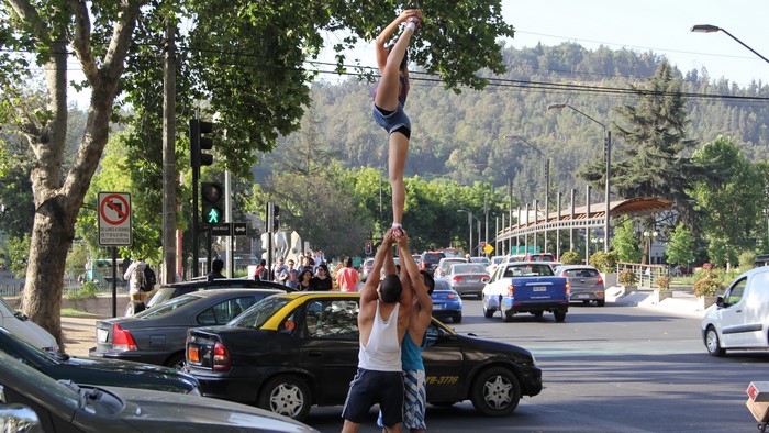 Cheerleaders performing a stunt on cars in Valparaiso, Chile