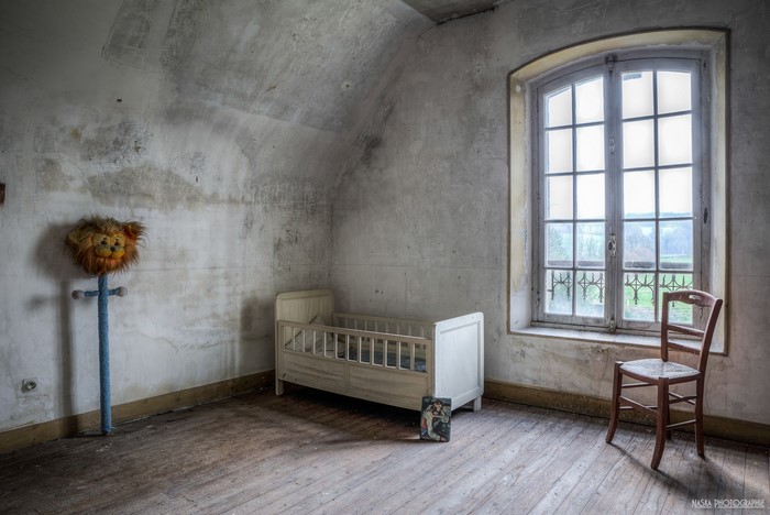 Abandoned room with crib and lion toy