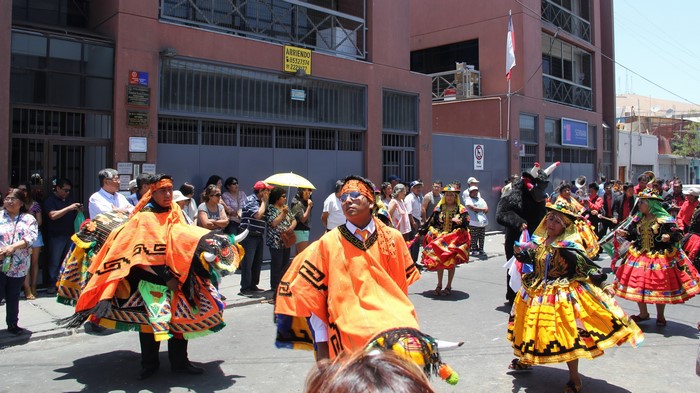 People in costumes celebrating a street festival in Chile