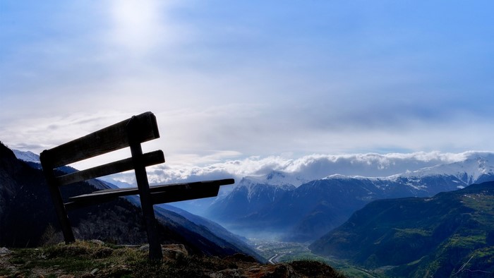 Bench overlooking a misty mountain valley