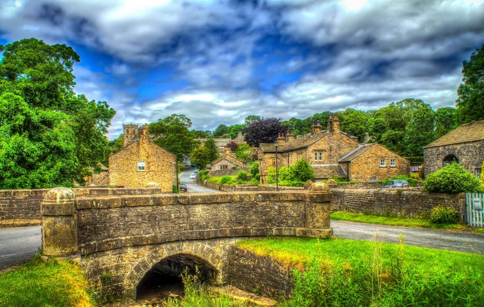 Stone bridge and houses in Downham, England
