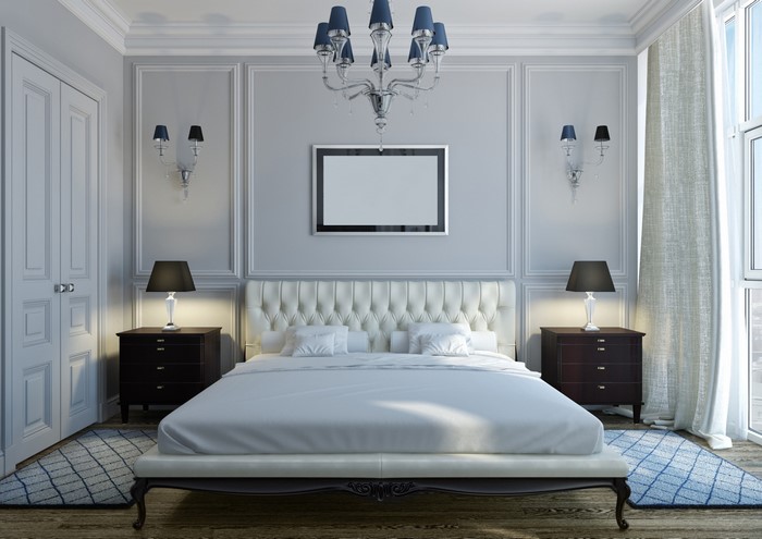 Luxurious bedroom with tufted bed and chandelier