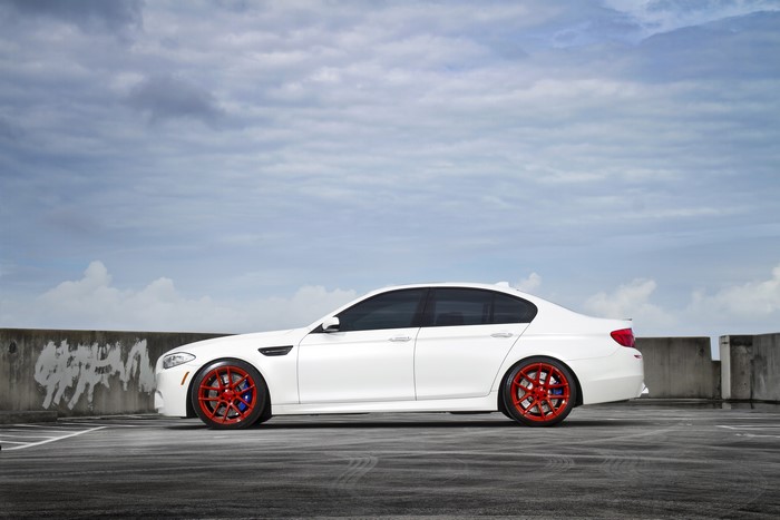 White BMW M5 F10 on a rooftop parking lot