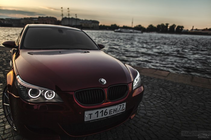 Red BMW M5 by the Water