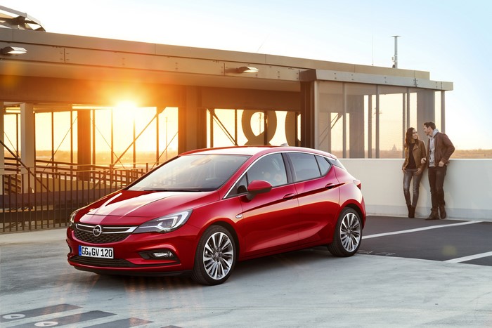 Red Opel Astra with Couple at Sunset