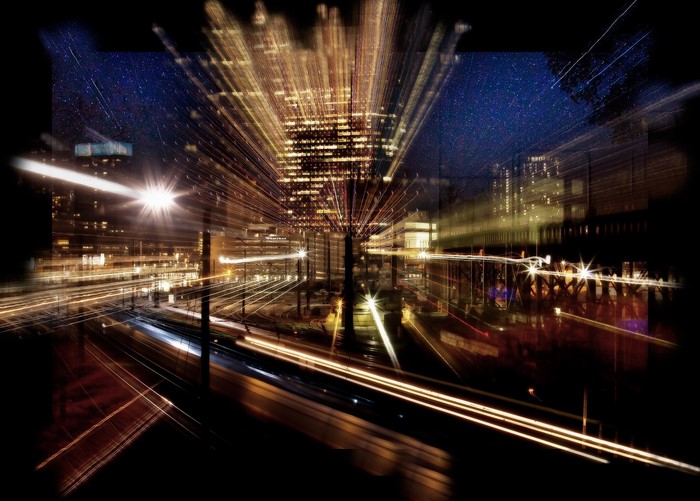 Night cityscape with light trails and stars