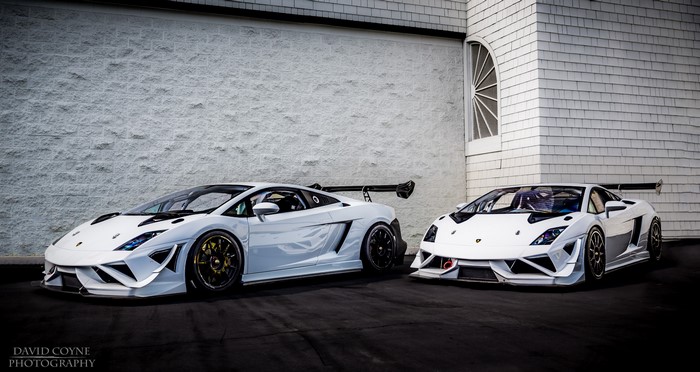 Two white Lamborghini Gallardo cars parked outside